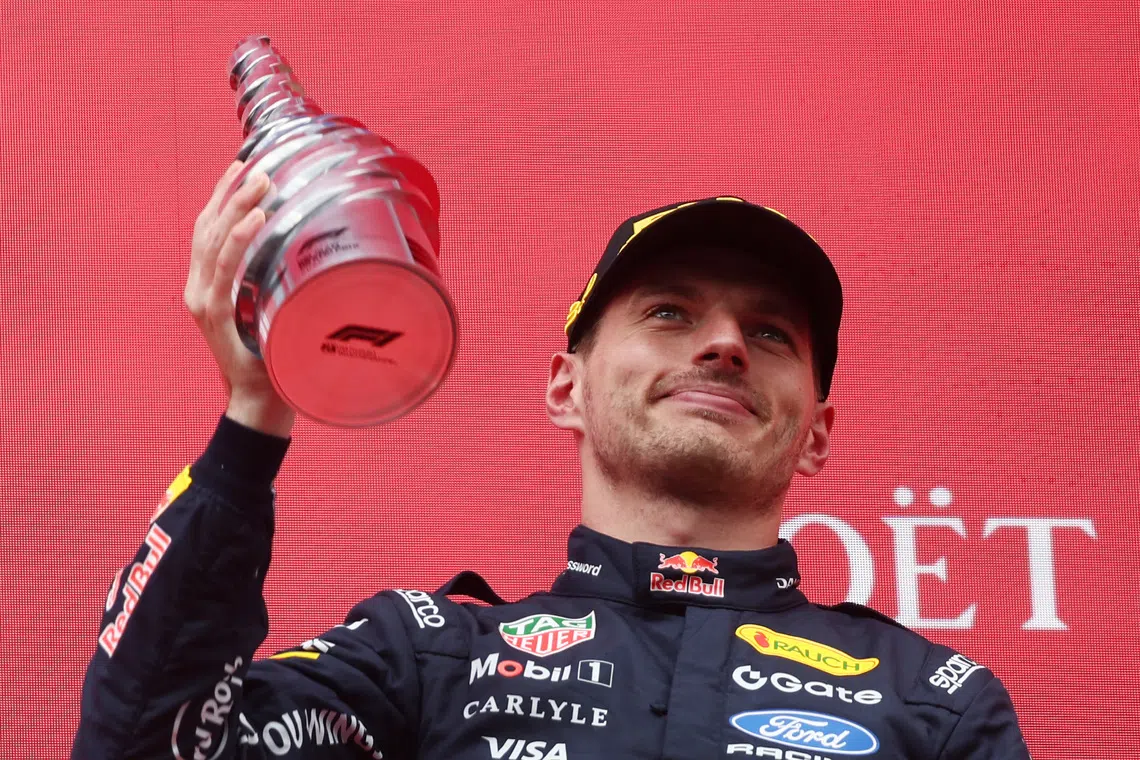 FILE PHOTO: Formula One F1 - Belgian Grand Prix - Circuit de Spa-Francorchamps, Stavelot, Belgium - July 19, 2026 Red Bull's Max Verstappen celebrates with a trophy on the podium after finishing third place in the Belgian Grand Prix REUTERS/Jakub Porzycki/File Photo