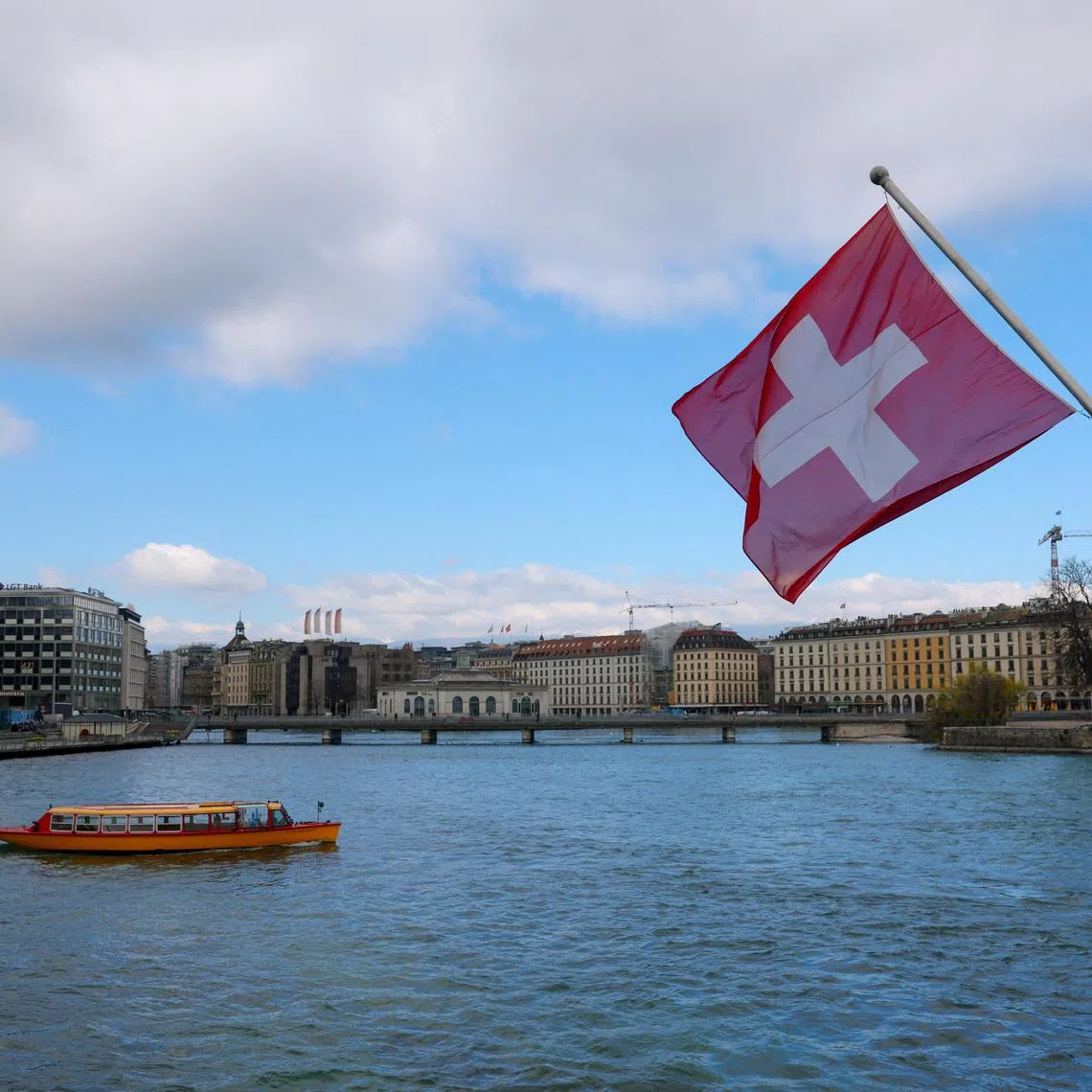A Swiss flag and a mouette boat, as seen from the Mont Blanc bridge, in Geneva, Switzerland, March 18, 2026. REUTERS/Denis Balibouse