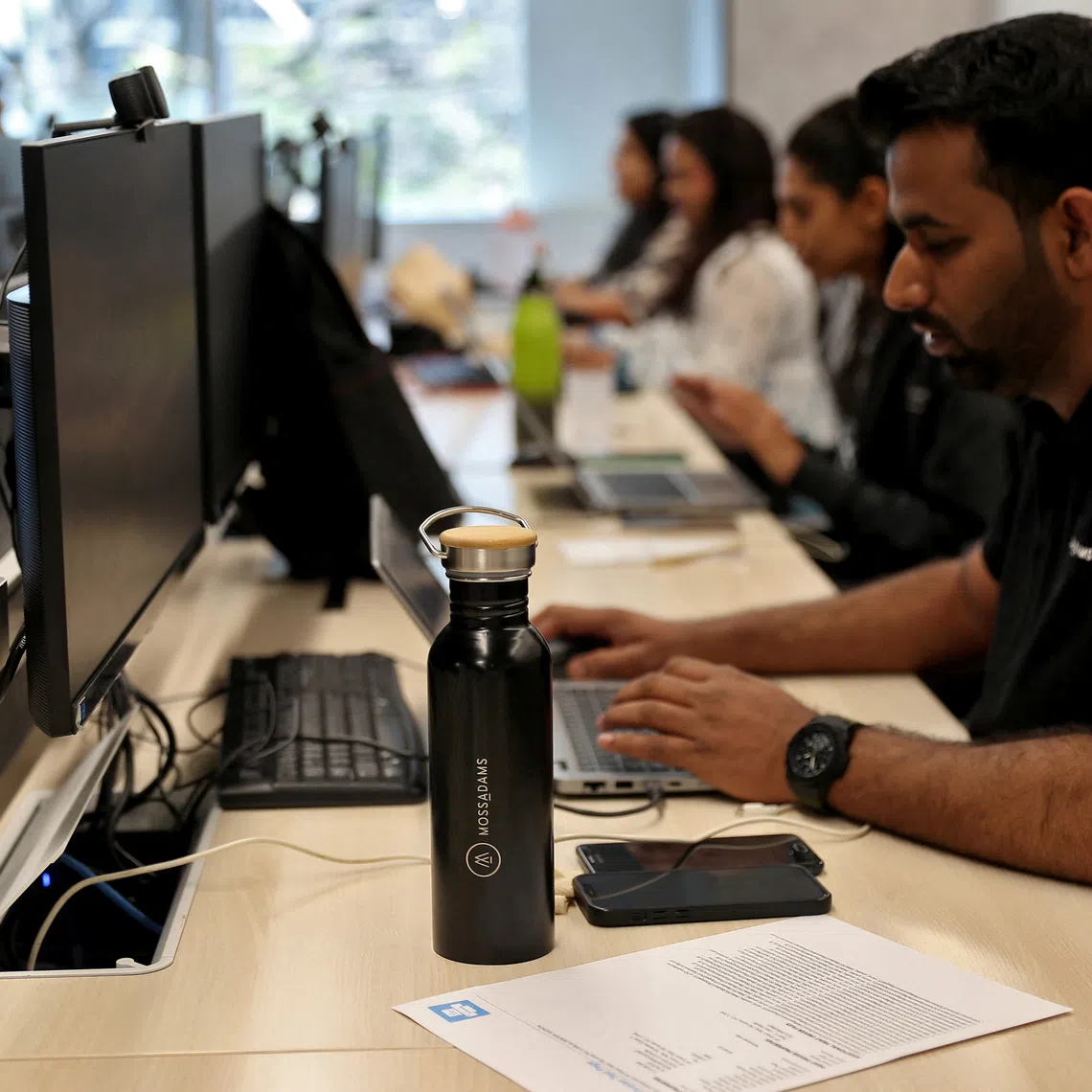 Employees work inside the office of Moss Adams, a U.S. accounting firm, in Bengaluru, India, April 23, 2025. REUTERS/Stringer