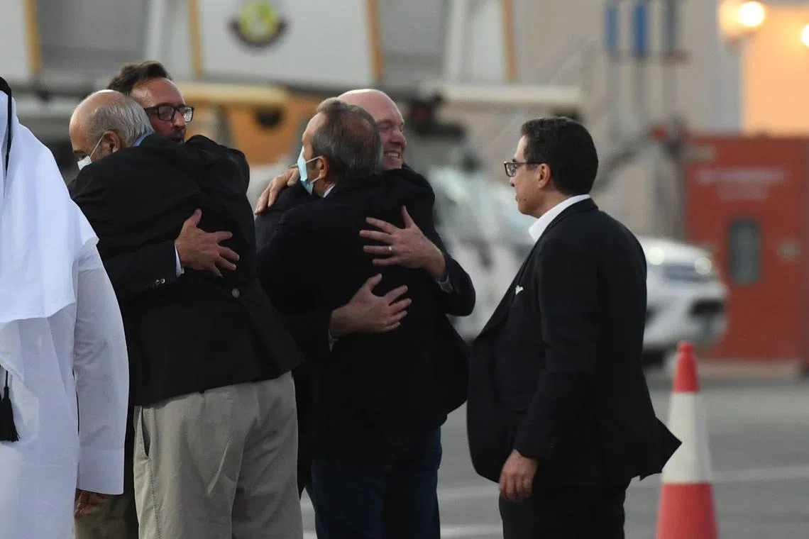 US nationals Siamak Namazi (right), Emad Sharqi (left) and Morad Tahbaz (centre), who were among five prisoners released from Iran, are received upon landing in Doha on Monday. 