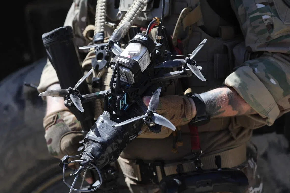 A soldier of the French Army Robotics Exploration Section holds an FPV drone during a dynamic demonstration of military equipment at the Eurosatory defence and security trade show at the Paris Nord Villepinte Exhibition Centre on June 14, 2026. 