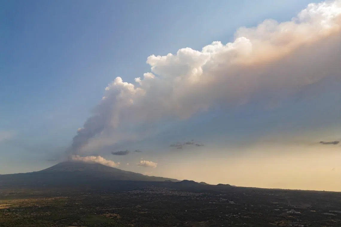 A drone view shows smoke rising from a crater of Mount Etna, Europe's most active volcano, in Belpasso, Italy July 23, 2024. REUTERS/Etna Walk/Marco Restivo