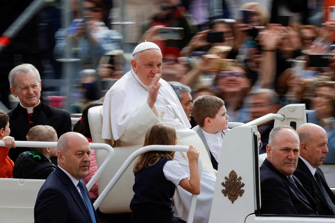 FILE PHOTO: Pope Francis waves at people on the day of the weekly general audience, in St. Peter's Square at the Vatican, May 8, 2024. REUTERS/Ciro de Luca/File Photo