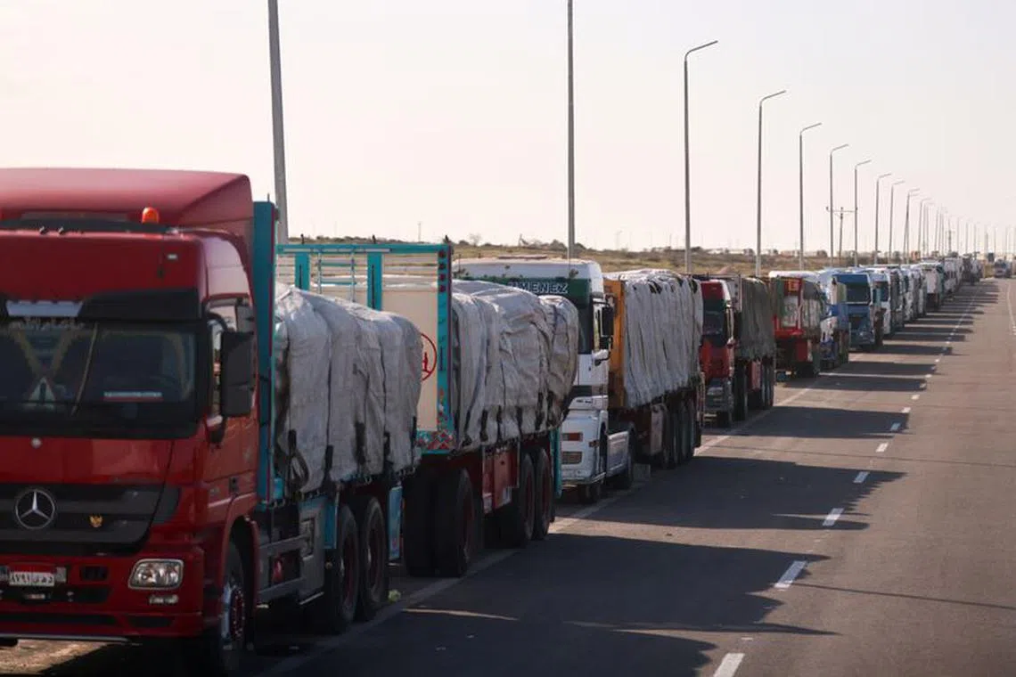FILE PHOTO: Trucks carrying aid line up near the Rafah border crossing between Egypt and the Gaza Strip, amid the ongoing conflict between Israel and Palestinian Islamist group Hamas, in Rafah, Egypt, February 1, 2024. REUTERS/Mohamed Abd El Ghany