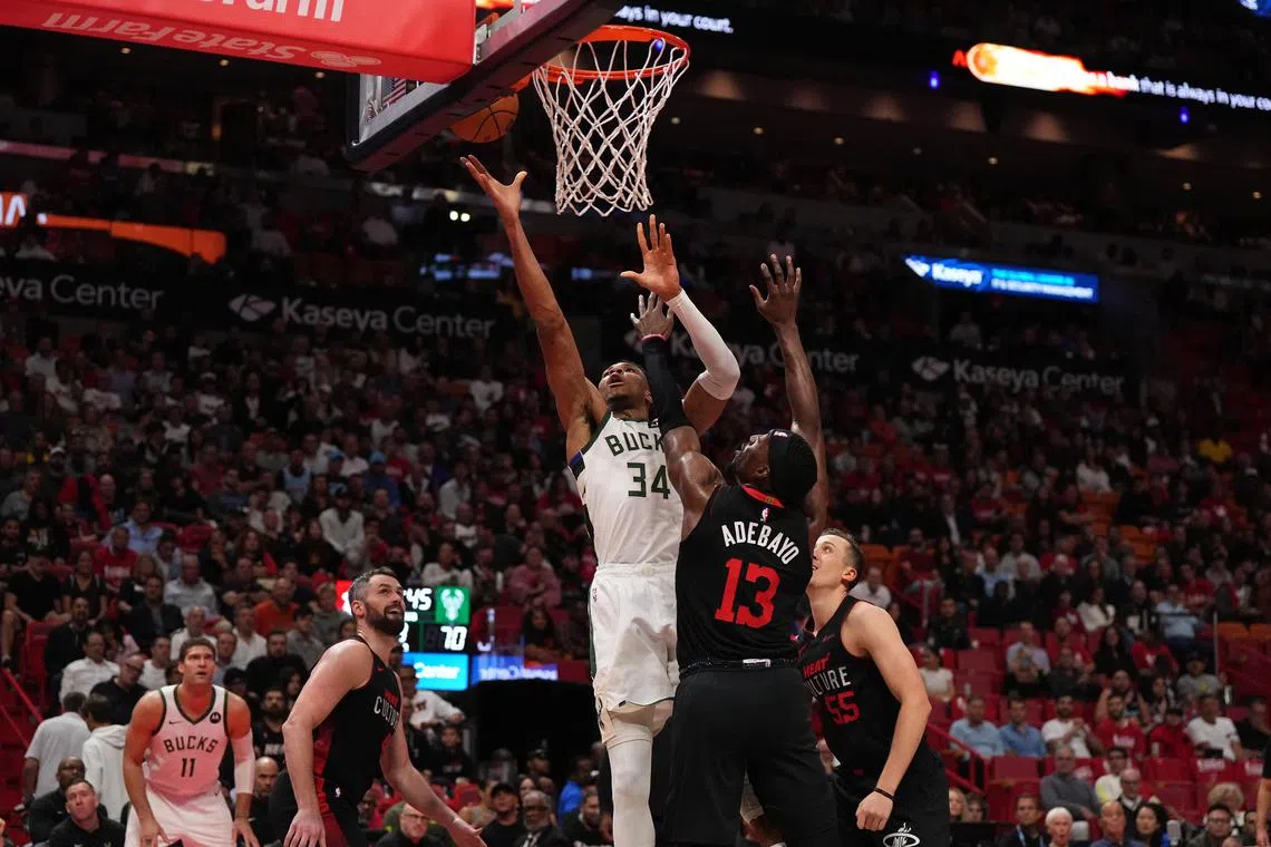 Milwaukee Bucks forward Giannis Antetokounmpo shoots the ball against Miami Heat centre Bam Adebayo during the second half at Kaseya Centre.
