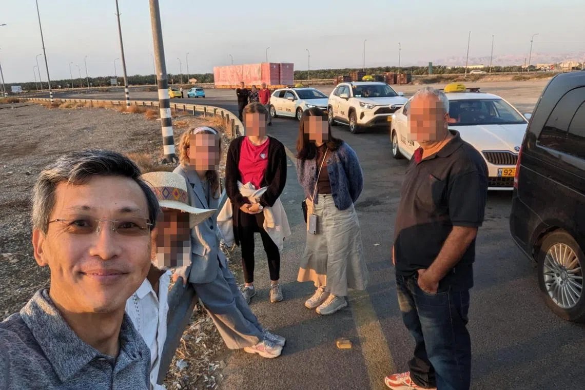 Mr Lim and other passengers waiting to cross over the security checkpoint at King Hussein Bridge to enter Amman, the capital of Jordan. 