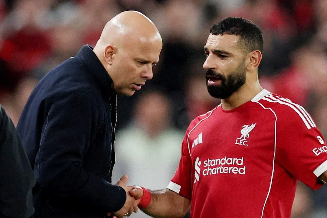 FILE PHOTO: Soccer Football - UEFA Champions League - Round 16 - Second Leg - Liverpool v Galatasaray - Anfield, Liverpool, Britain - March 18, 2026 Liverpool's Mohamed Salah shakes hands with manager Arne Slot after being substituted REUTERS/Phil Noble/File Photo