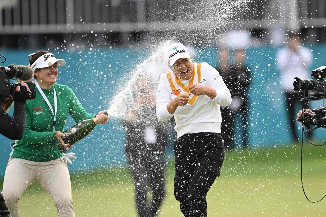 Minjee Lee is sprayed with champagne by fellow Australian Hannah Green after winning the BMW Ladies Championship at Seowon Hills Country Club in Paju on Sunday.