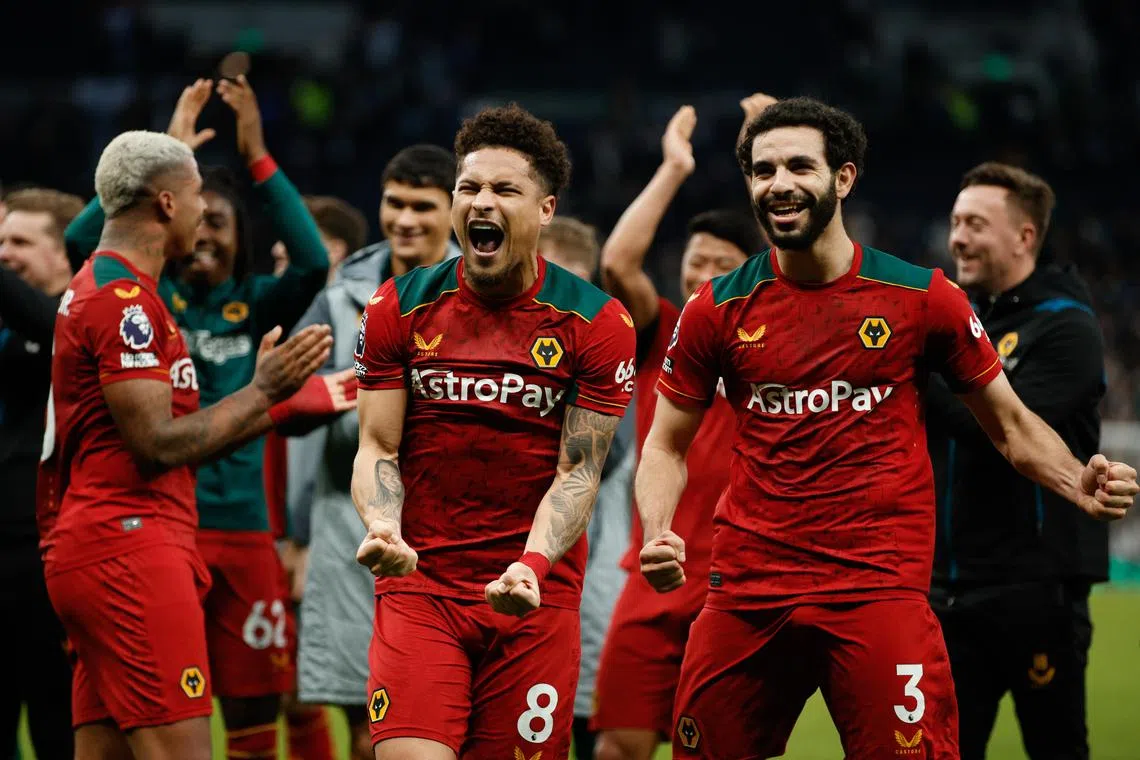 Wolves' Joao Gomes celebrates with his teammates after winning the match.