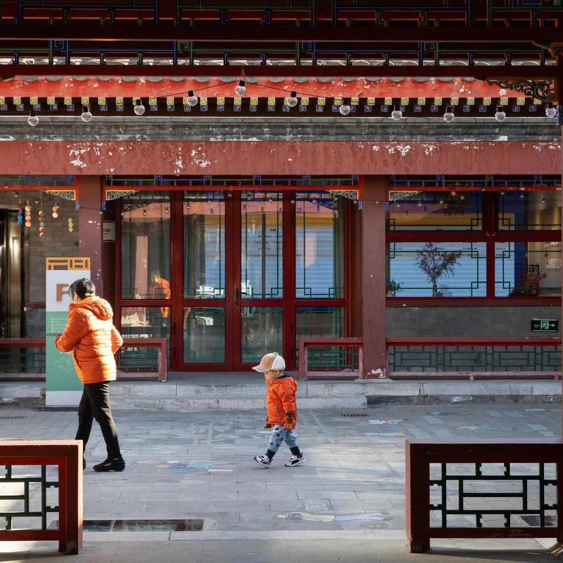 A family plays in a courtyard in Beijing, China, on Nov 27. 