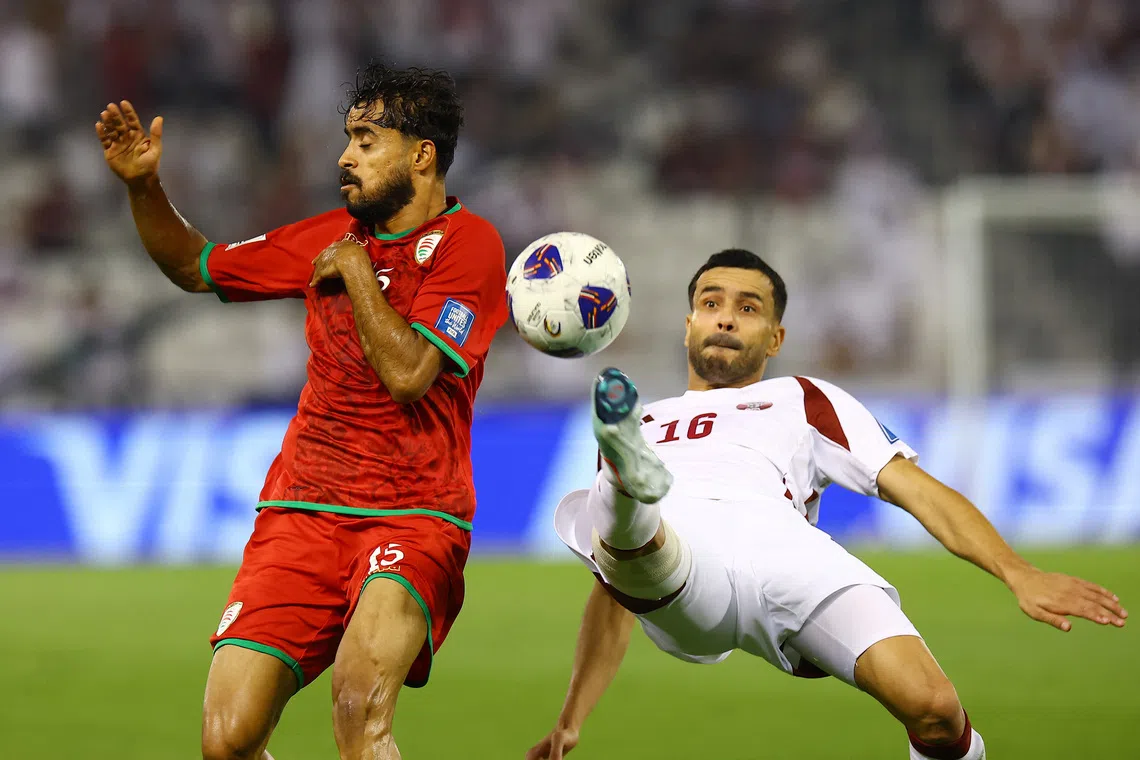 Soccer Football - FIFA World Cup - AFC Qualifiers - Group A - Oman v Qatar - Jassim Bin Hamad Stadium, Doha, Qatar - October 8, 2025 Qatar's Boualem Khoukhi in action with Oman's Nasser Al Rawahi REUTERS/Ibraheem Al Omari