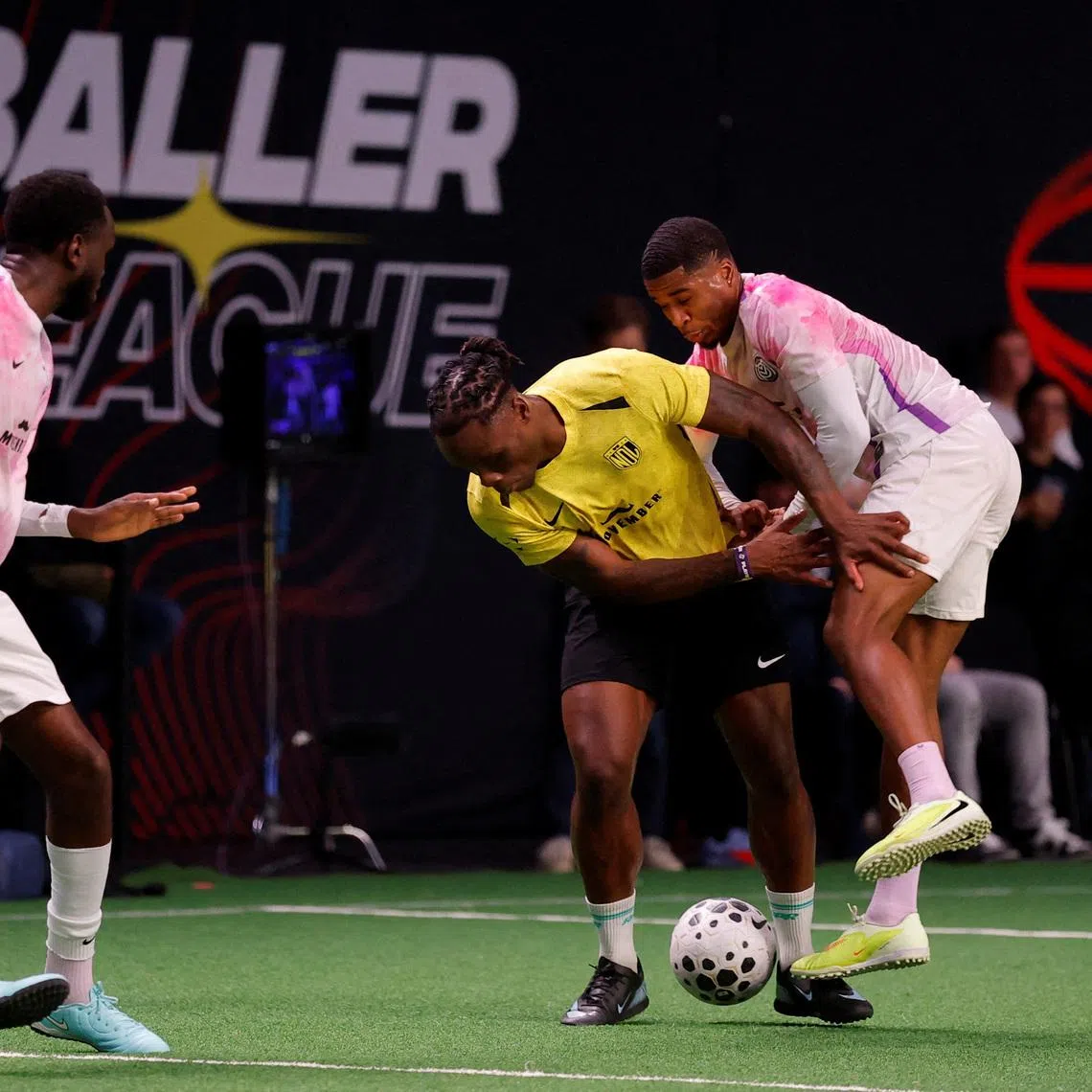 FILE PHOTO: Soccer Football - Baller League - Matchday 8 - MVPs United v NDL FC - Copper Box Arena, London, Britain - December 15, 2025 NDL FC's Razzaq Coleman in action with MVPs United's Montel McKenzie Action Images via Reuters/Andrew Couldridge/File Photo