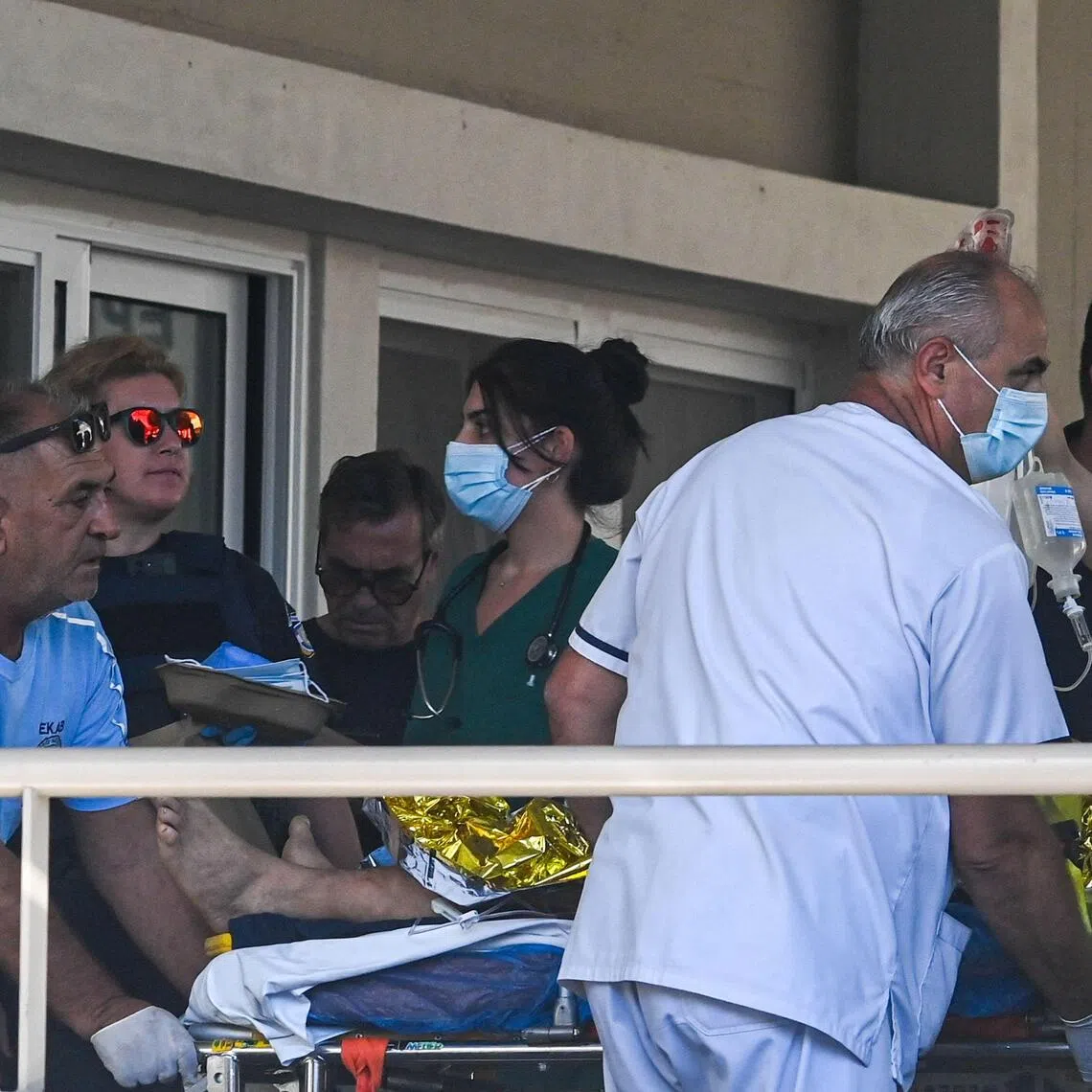 An injured man arriving for hospital treatment on Oct 9, following an oil refinery accident in Greece.