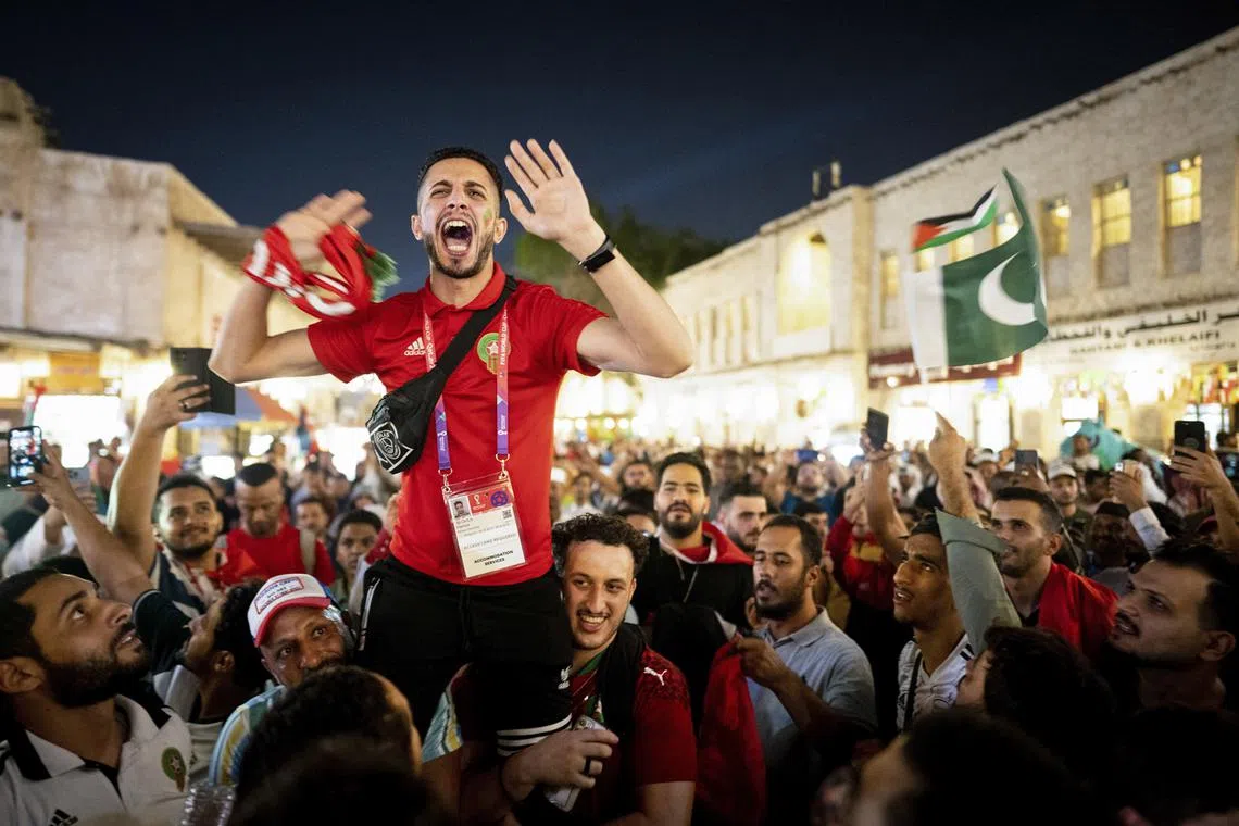 Fans celebrate in Souq Waqif after Morocco defeated Spain at the 2022 World Cup in Doha, Qatar on Dec 6, 2022. After a defensive struggle, Morocco knocked Spain out of the World Cup in a 3-0 penalty shootout. 