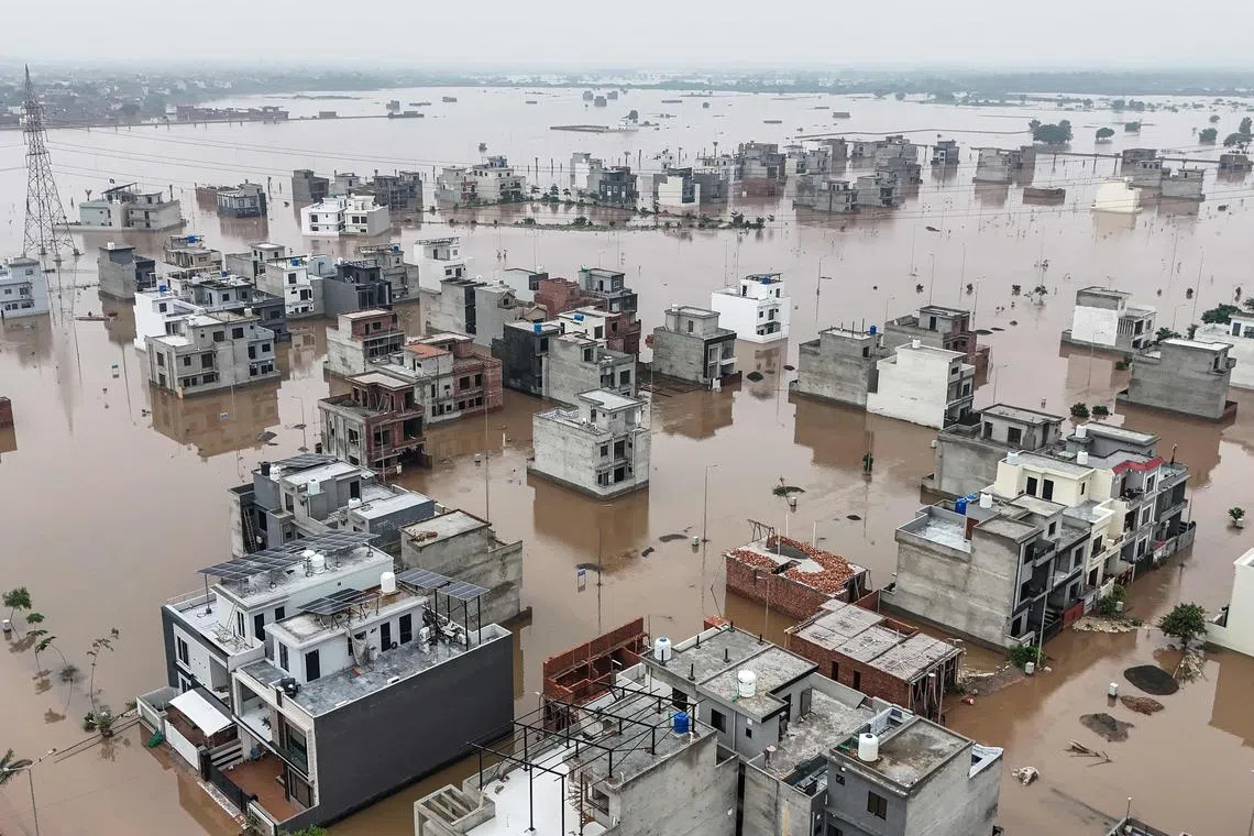 Partially submerged residential buildings following the overflowing of the Ravi River in Lahore, Pakistan, on Aug 30.
