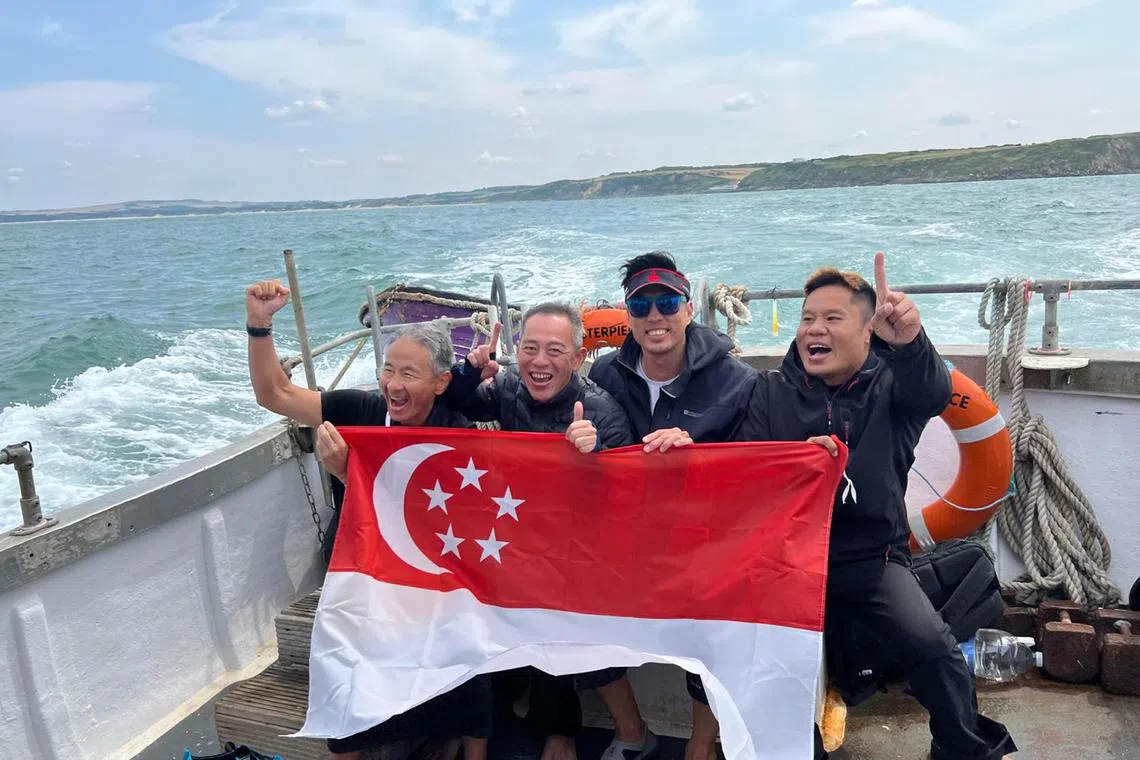 tbswim22 - (From left) holding the Singapore flag after becoming the Republic's first relay team to complete a swim across the English Channel on July 21.

Credits: Courtesy of Ng Chee Soon