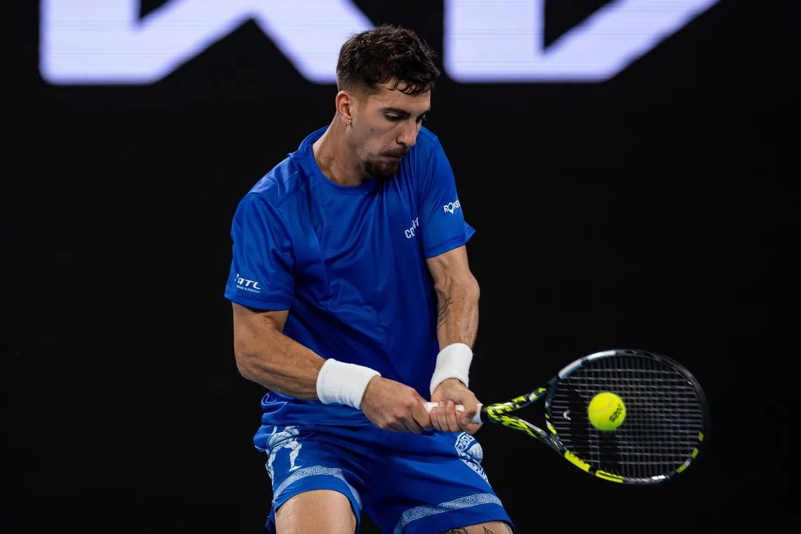 Jan 15, 2025; Melbourne, Victoria, Australia; Thanasi Kokkinakis of Australia plays a backhand during his match against Jack Draper of United Kingdom in the second round of the men's singles at the 2025 Australian Open at Melbourne Park. Mandatory Credit: Mike Frey-Imagn Images