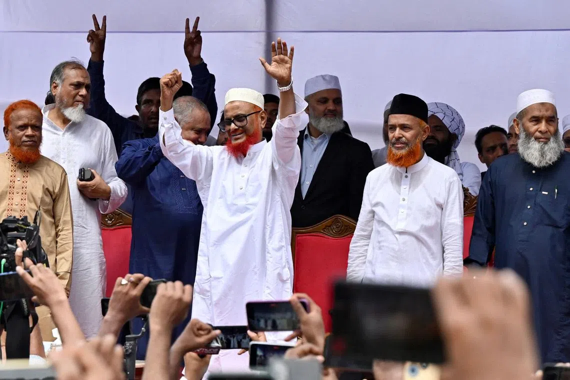 Bangladesh's Jamaat-e-Islami leader A.T.M. Azharul Islam (centre) gestures after he was released from prison in Dhaka on May 28, 2025. 