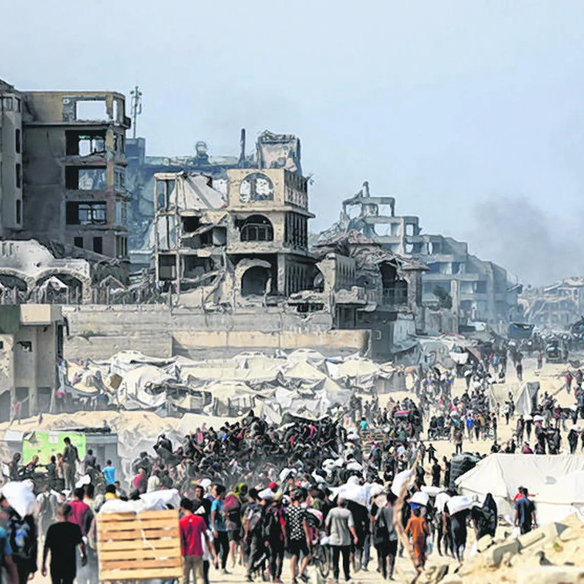 Palestinians carry aid supplies they collected from trucks that entered Gaza through Israel, in Beit Lahia, in the northern Gaza Strip, on Aug 10.