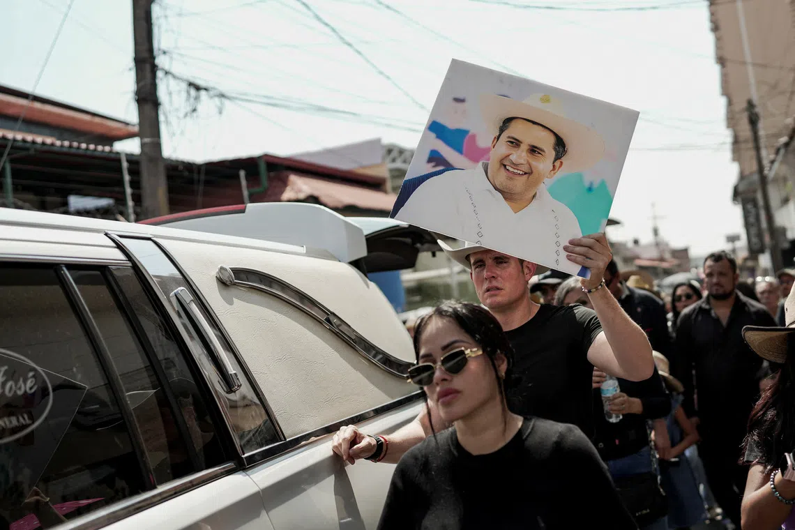A person holds a picture of Carlos Manzo, the mayor who was shot dead during a Day of the Dead event, in Uruapan, Mexico, November 2, 2025. REUTERS/Ivan Arias