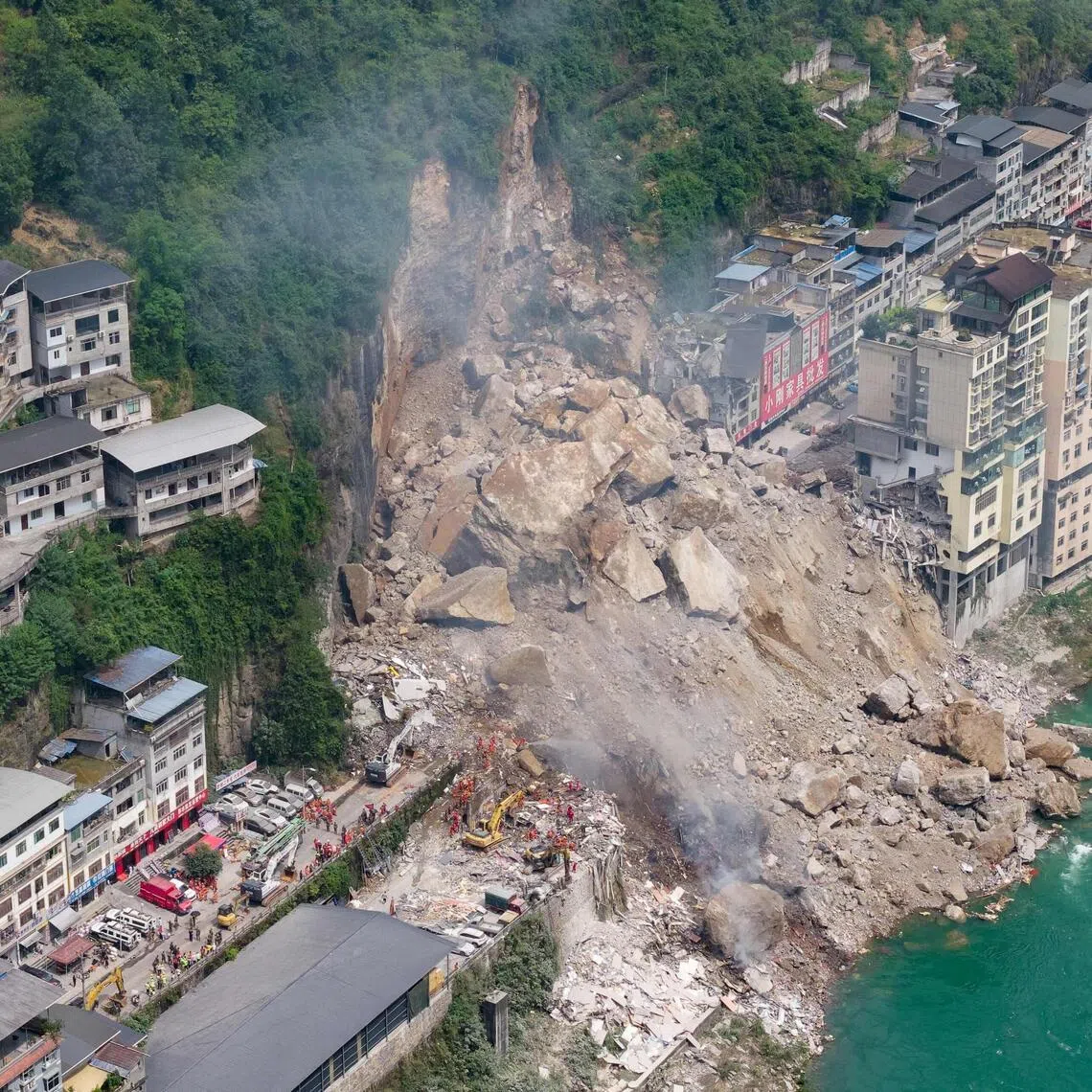 Rescue workers searching for survivors at the site of a landslide in Pengshui county in Chongqing, China, on July 17.