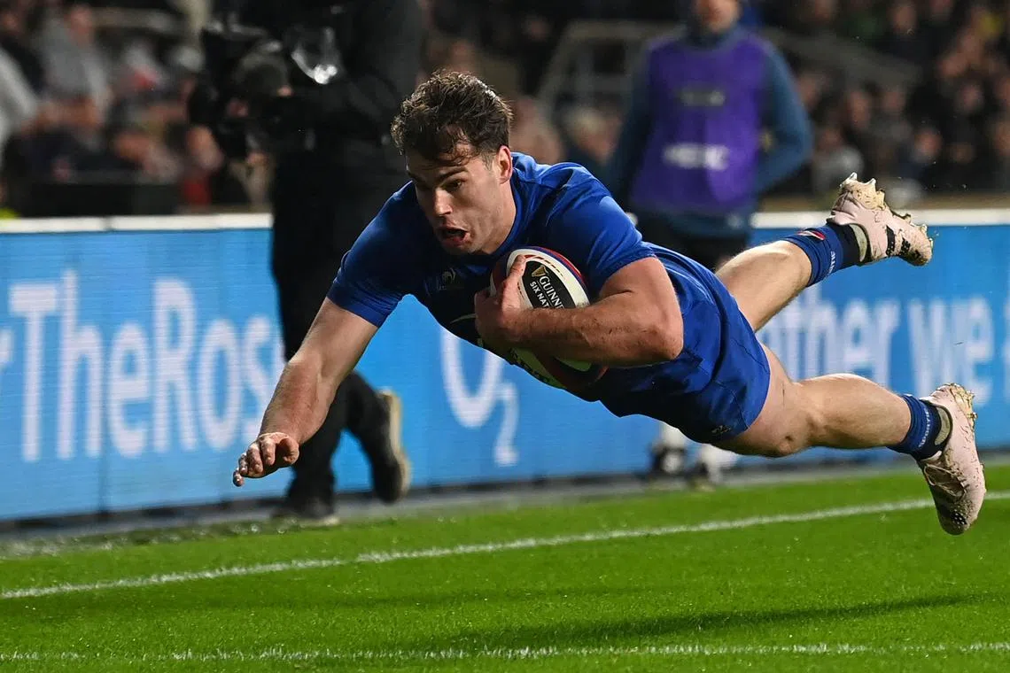 France's winger Damian Penaud diving over the line to score his second try during the Six Nations international rugby union match between England and France at Twickenham. France won 53-10.