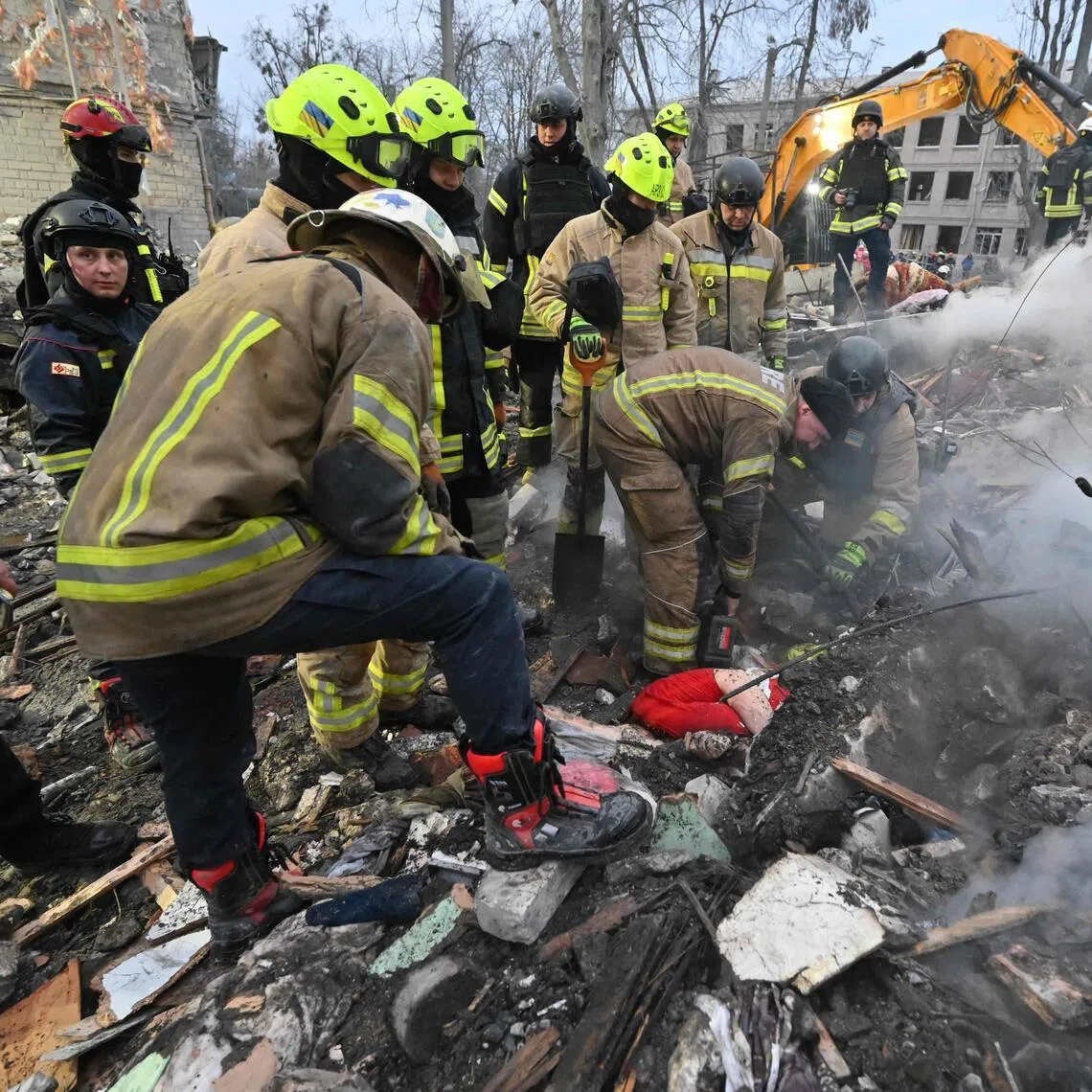 Rescuers retrieving the body of a victim from under the rubble of a five-storey residential building in Kharkiv that was hit by a ballistic missile on March 7.