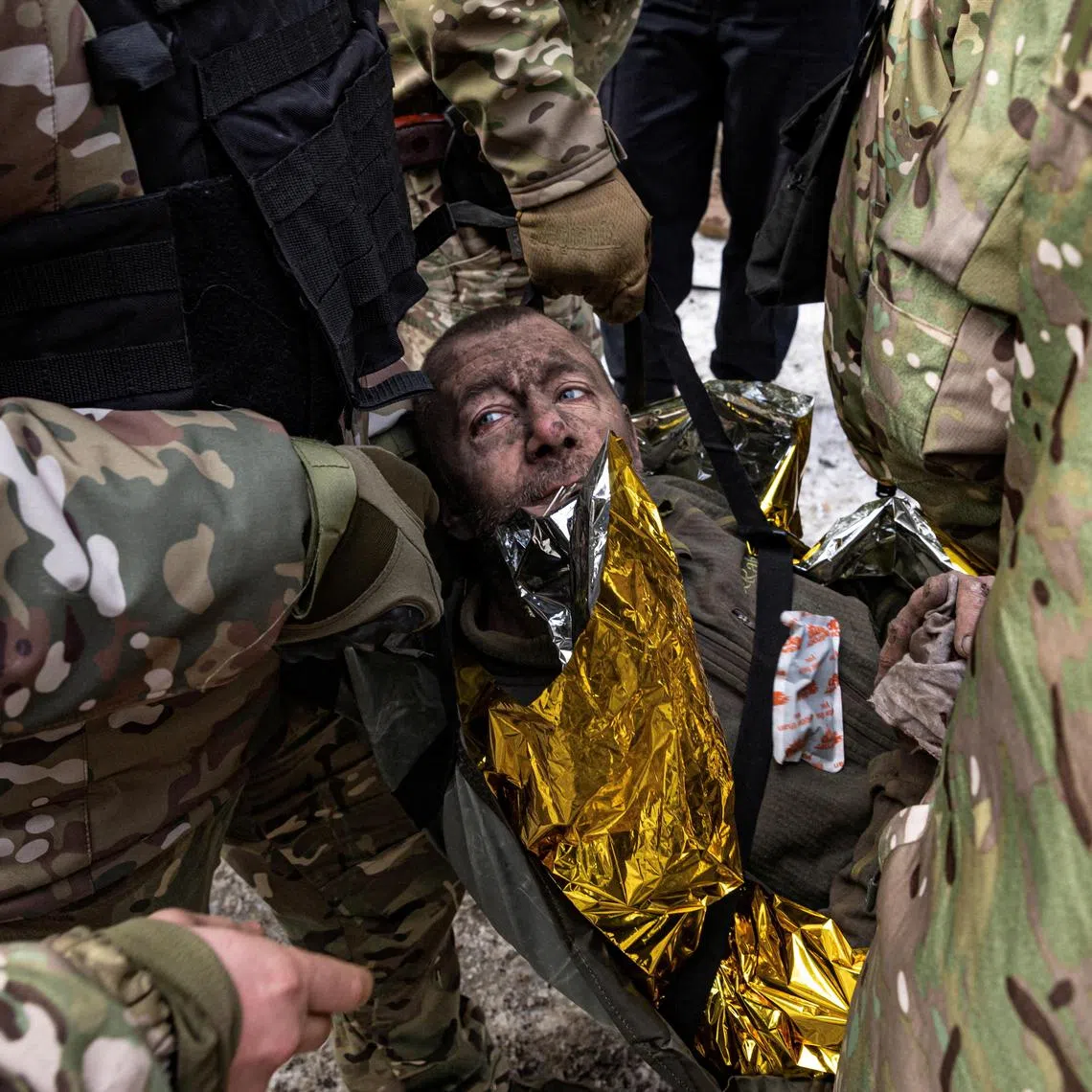 A man is rescued by firefighters after an apartment block was heavily damaged by a missile strike in Pokrovsk, Ukraine.