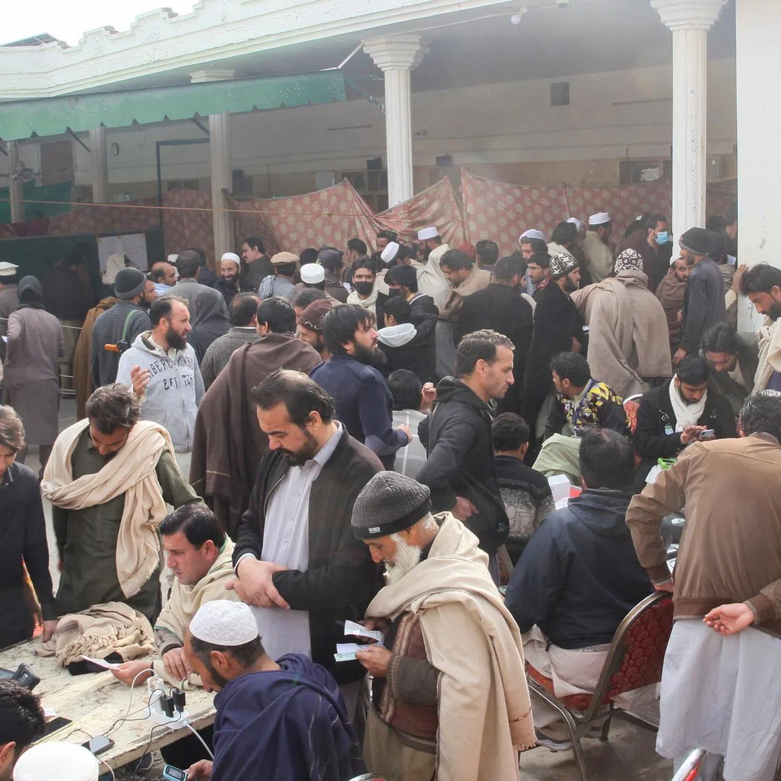 Residents who fled a remote mountainous region bordering Afghanistan gathering to get themselves registered in Bara, Pakistan, on Jan 30.