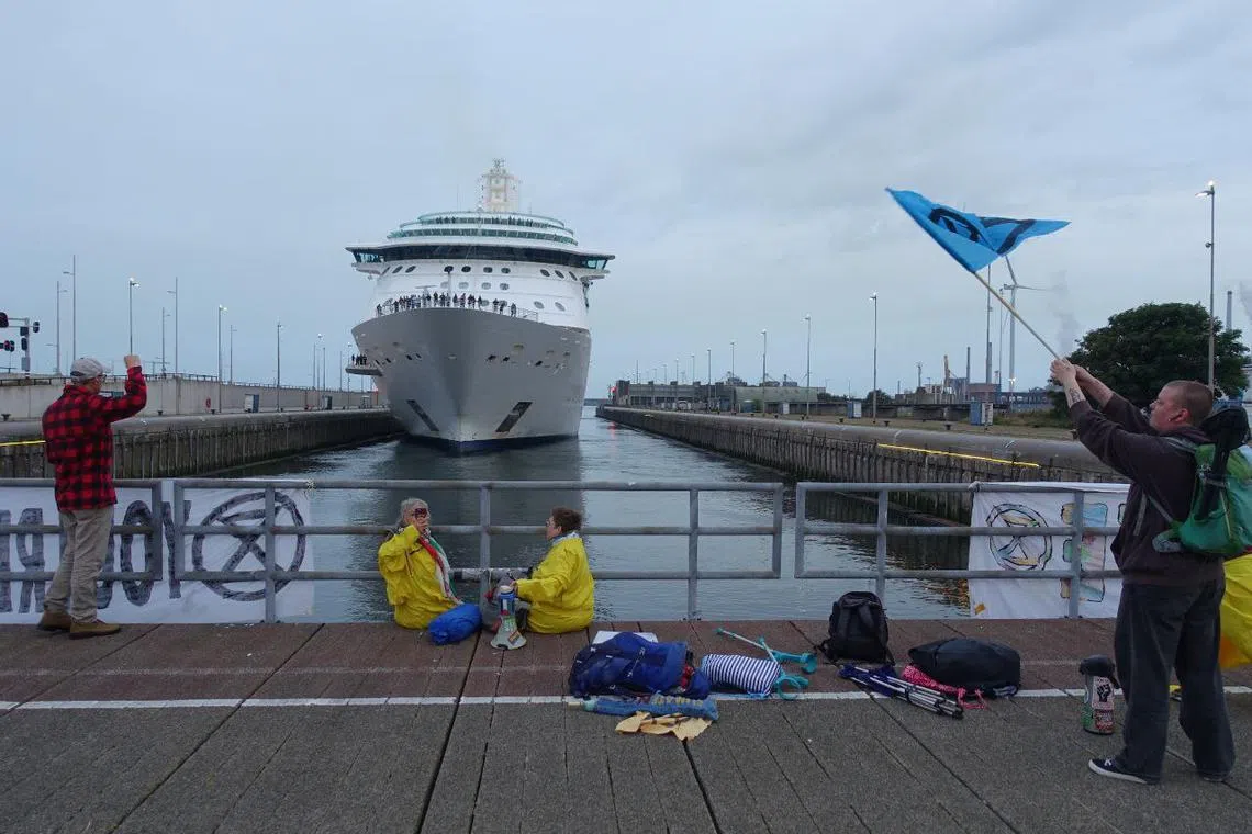 The action was carried out by Extinction Rebellion, which has called for an end to visits by the highly polluting vessels to the Dutch city.