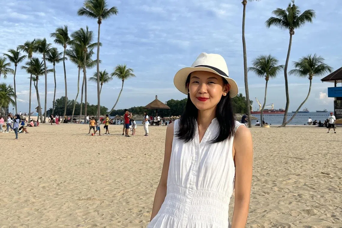 Museum curator Jackie Yoong enjoying the sun on Siloso Beach, Sentosa, in July 2023. 