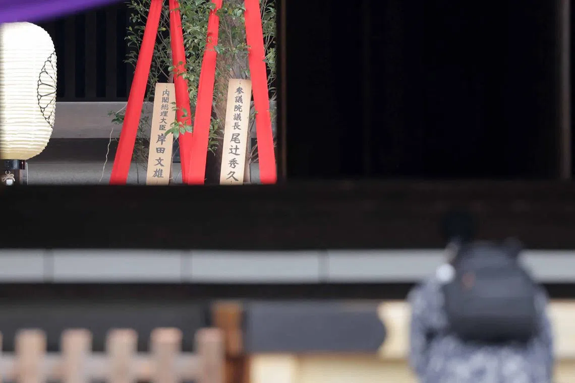 A plaque showing Japan's PM Fumio Kishida's name with a "masakaki" tree (left) that he sent as an offering to the Yasukuni Shrine on April 21.