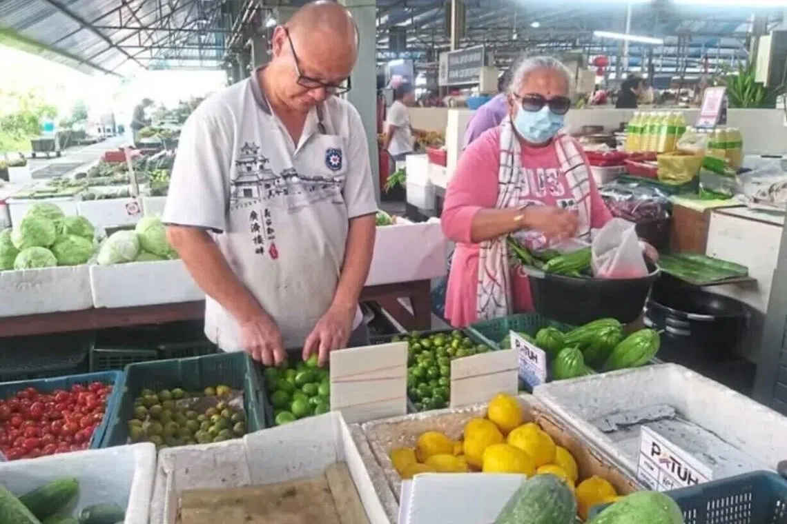 Vegetable seller Phua Ming Hui (left) said customers might have to bring their own bags or containers if sellers start reducing the use of plastic bags.