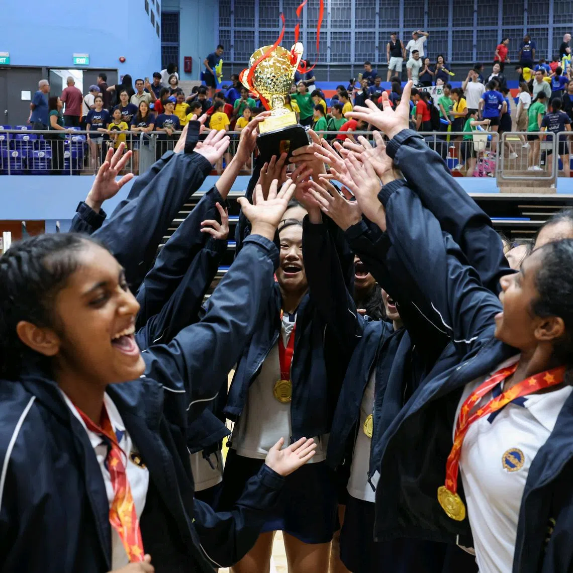 Methodist Girls' School players celebrating their win against CHIJ Secondary in the C Division netball final on Aug 29.