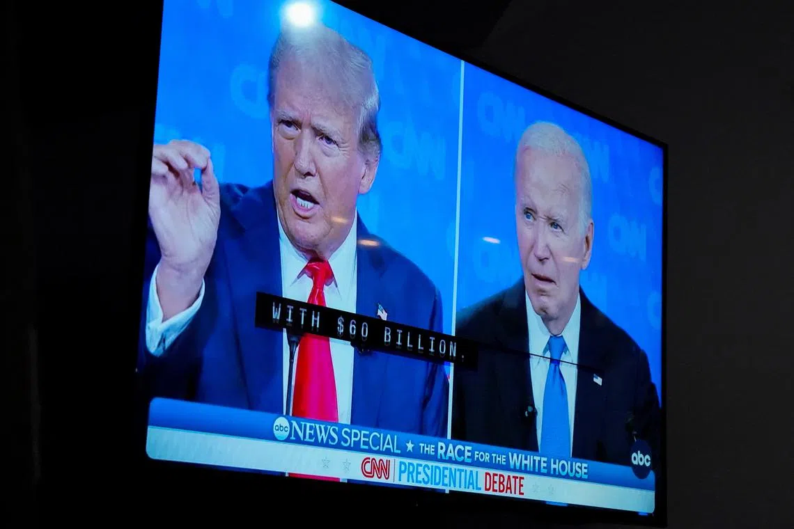 A TV screen shows the debate as The New Hanover County Democratic party hosts a watch party as U.S. President Joe Biden and former U.S. President Donald Trump face off in the first presidential debate of the 2024 election, in Wilmington, North Carolina, U.S. June 27, 2024.  REUTERS/Allison Joyce