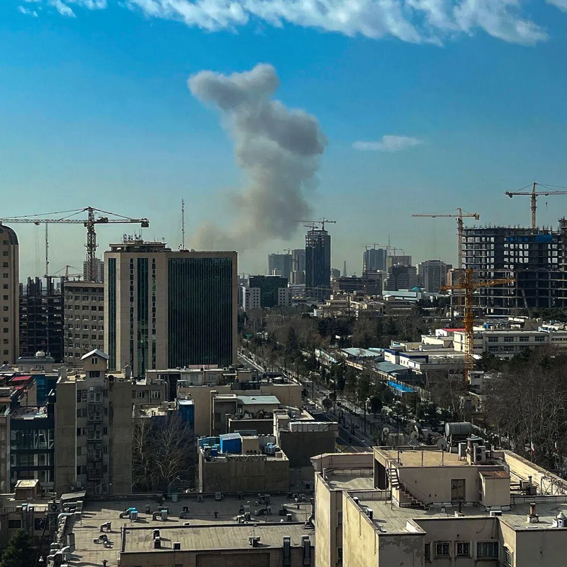 A plume of smoke rises following a reported explosion in Tehran on Feb 28.