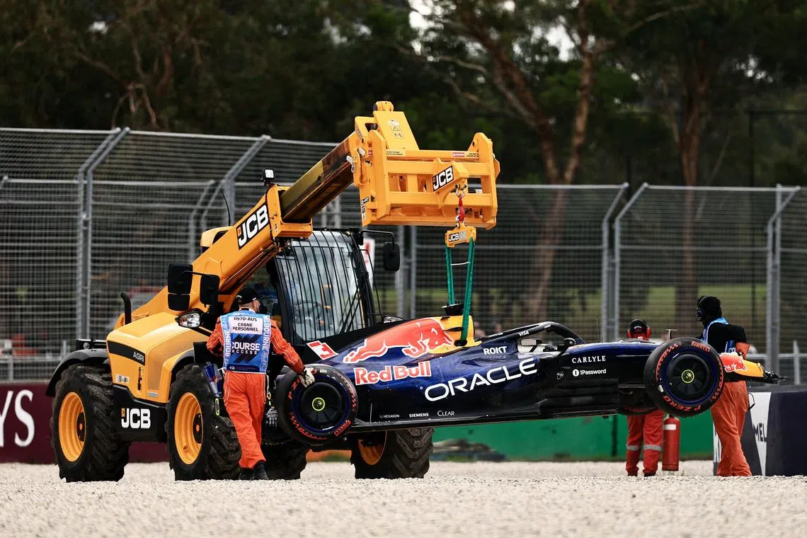 Formula One F1 - Australian Grand Prix - Albert Park Grand Prix Circuit, Melbourne, Australia - March 7, 2026 Marshals remove Red Bull's Max Verstappen car from the race track with a crane after crashing out during qualifying REUTERS/Mark Peterson