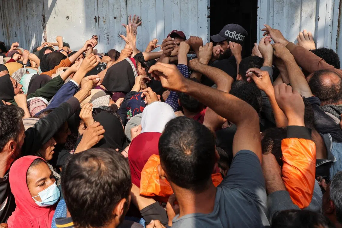 Palestinians waiting to buy bread from a bakery in the central Gaza Strip on Nov 10.