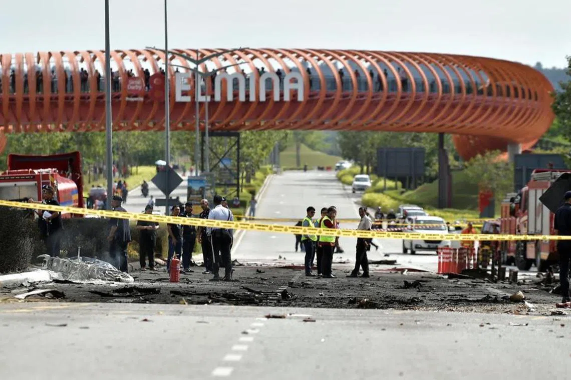 Officials inspecting the road after a Beechcraft 390 Premier 1 aircraft flying from Langkawi to Subang crashed onto the Guthrie Corridor Expressway in the township of Elmina, Shah Alam,on Aug 17. 