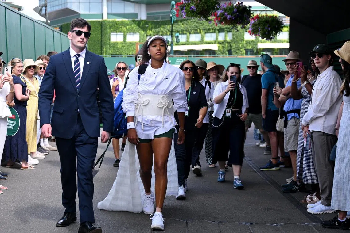 Tennis - Wimbledon - All England Lawn Tennis and Croquet Club, London, Britain - July 1, 2026 Japan's Naomi Osaka walks to the court ahead of her second round match against Russia's Anastasia Gasanova REUTERS/Jaimi Joy
