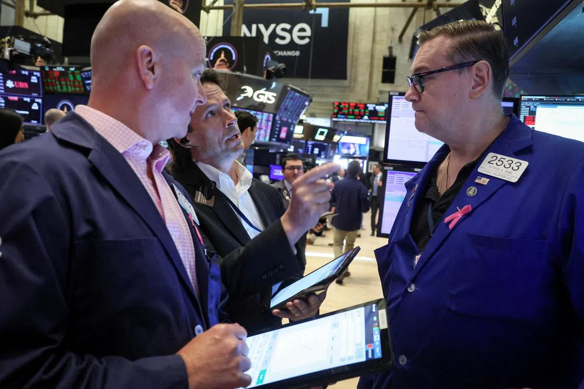 Traders work on the floor of the New York Stock Exchange, in New York City.