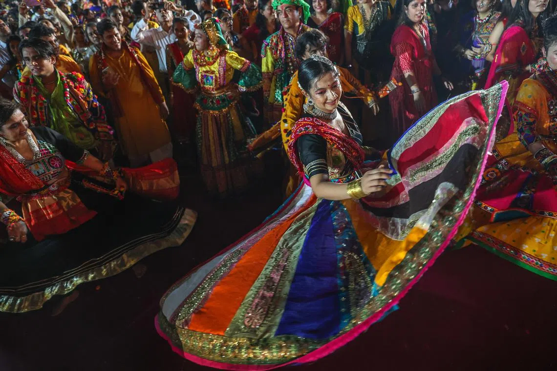 Indian women wearing traditional costumes participating in a Garba dance performance during the Navratri festival celebrations in Mumbai, India, Oct 3 2024. 