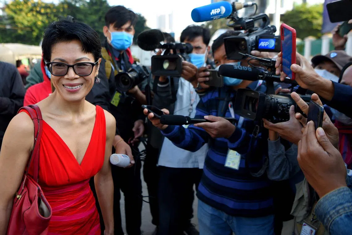 In this file photo taken on Jan 14, 2021, Cambodian-American human rights advocate Theary Seng (left) smiles as she walks in front of Phnom Penh municipal court in Phnom Penh. 