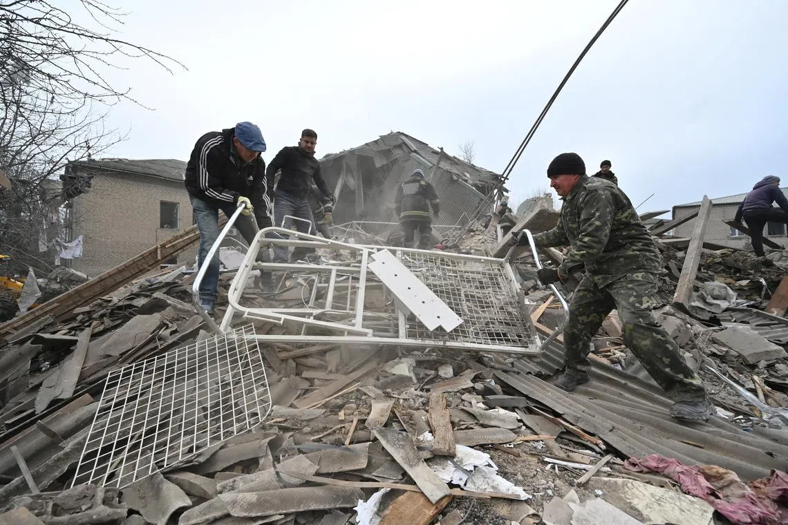 Rescuers work at the site of a maternity ward of a hospital destroyed by a Russian missile attack, in Vilniansk, in Ukraine's Zaporizhzhia region, on Nov 23, 2022.