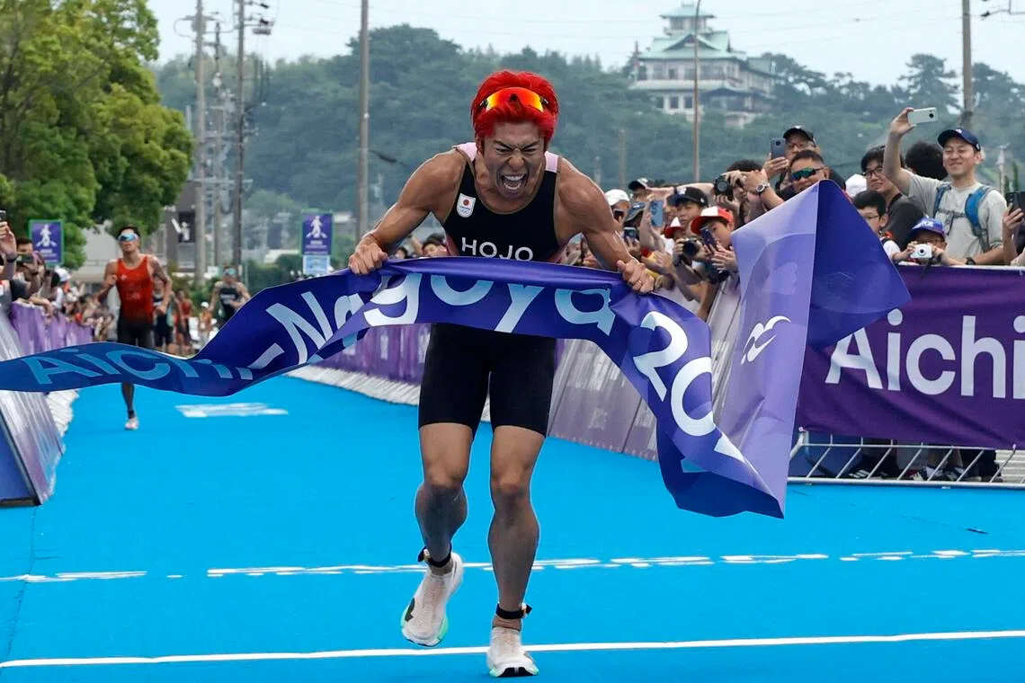 Asian Games - Aichi-Nagoya 2026 - Triathlon - Gamagori City Triathlon Venue, Gamagori, Japan - September 20, 2026
Japan's Takumi Hojo celebrates as he crosses the line to win the gold medal in the men's individual final REUTERS/Bryan Foo