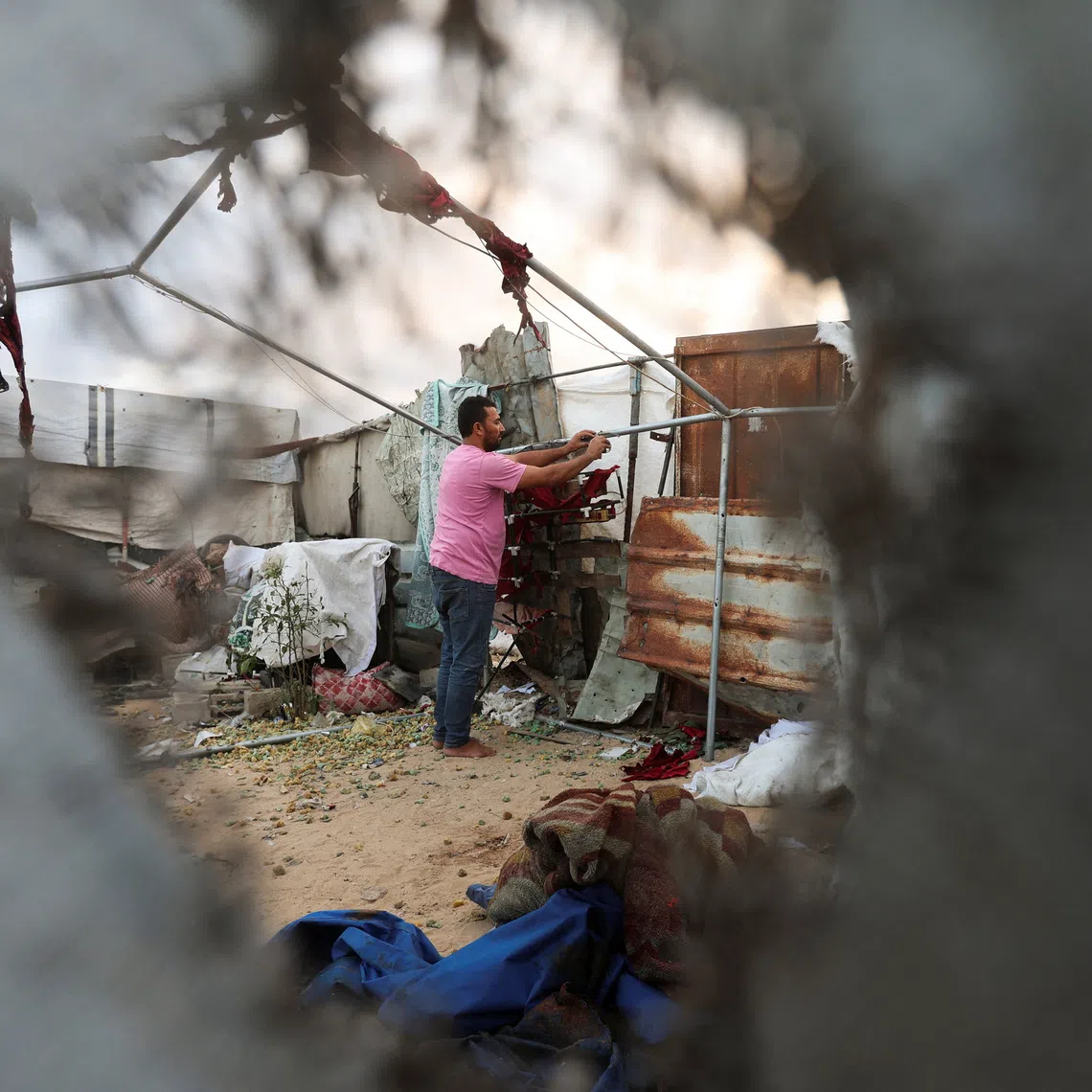 A Palestinian man inspects the site of an Israeli strike on a tent in Khan Younis, in the southern Gaza Strip, October 12, 2026. REUTERS/Ramadan Abed