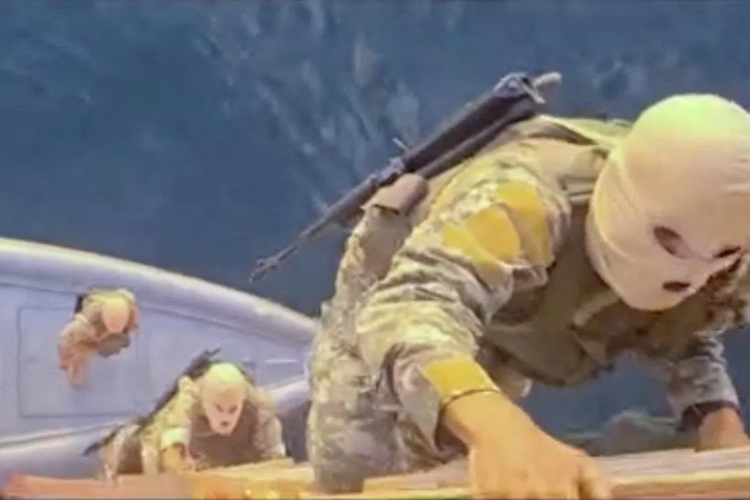 A screen capture from a video said to show the seizure of the container ships MSC Francesca and Epaminondas in the Strait of Hormuz, broadcasted on Iranian State TV, and released April 22, 2026, shows soldiers taking part in the operation. IRIB/Handout via REUTERS
