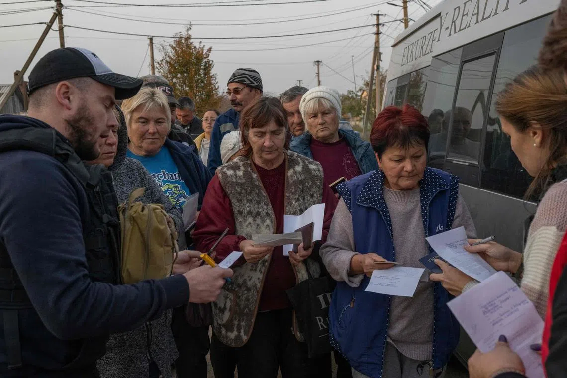 People waiting to receive humanitarian aid in the village of Lymany, outside Mykolaiv, on Nov 2, 2022.