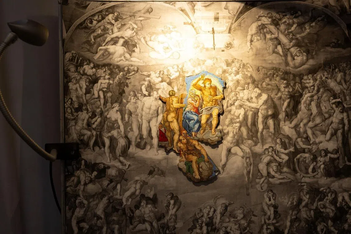 A section of a new mosaic is positioned over a reference drawing of Michelangelo’s Last Judgment inside the Vatican Mosaic Studio, at the Vatican, on Feb 19.