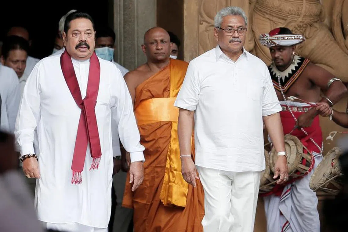 FILE PHOTO: Sri Lanka's Prime Minister Mahinda Rajapaksa and his brother, and Sri Lanka's President Gotabaya Rajapaksa are seen during his during the swearing in ceremony as the new Prime Minister, at Kelaniya Buddhist temple in Colombo, Sri Lanka, August 9, 2020. REUTERS/Dinuka Liyanawatte/File photo